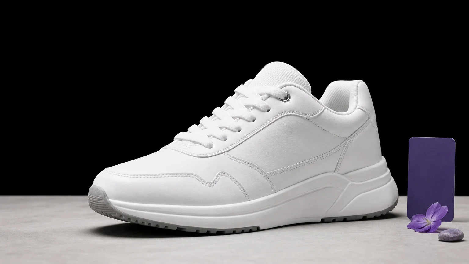 White sneaker prepared for placement on a black background